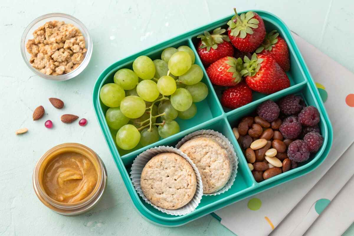 spread of delicious low FODMAP snacks including fruits, roasted chickpeas, and yogurt.